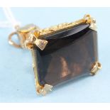 A modern 9ct gold fob seal set domed rectangular smoky quartz, 12.9g.