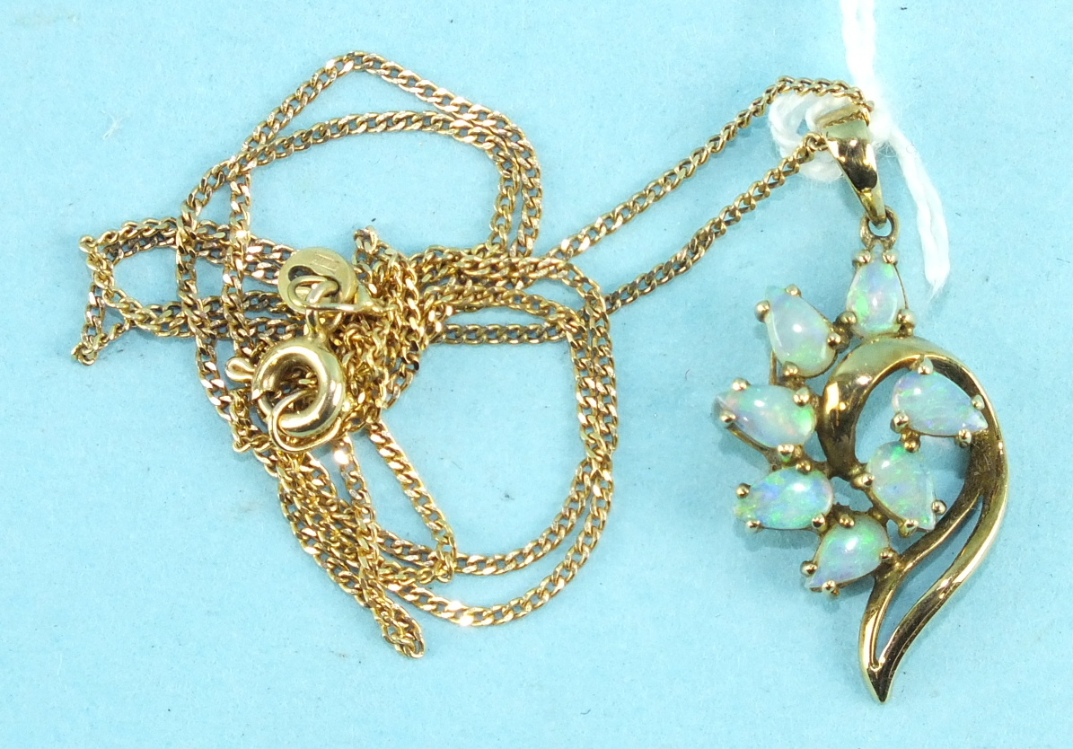 A 9ct gold pendant of scroll form set seven pear-shaped opals, on fine curb-link chain, 3.1g.