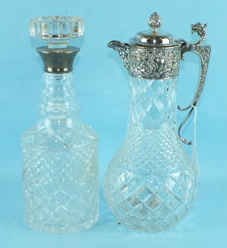 A modern cut glass claret jug with silver Cellini-style embossed mount, handle and finialled lid,