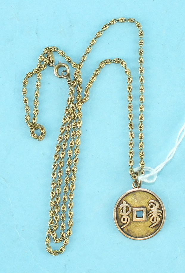 A 14k gold pendant in the form of a Chinese coin, on 14k gold chain, 10.6g.