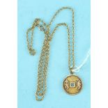 A 14k gold pendant in the form of a Chinese coin, on 14k gold chain, 10.6g.