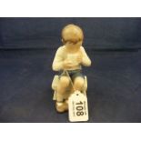 A B&G Copenhagen figurine of a boy sat on a stool