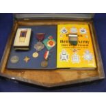 A display case of various medals (8) together with two related books