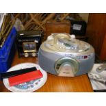 Two cd players together with two boxes and a poole pottery plate