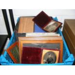 A carton containing a collection of frames to include silver, early portraits cased,