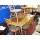 An ercol dining table together with six matching chairs