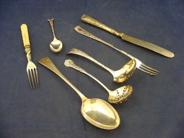 A selection of silver cutlery and flatware to include pierced spoons