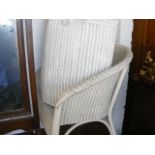 A lloyd loom chair together with a linen basket