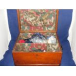 A wooden sewing box and contents