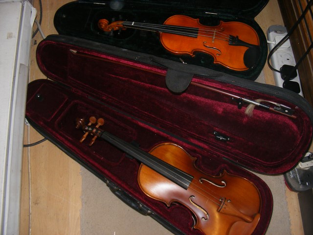 Two cased violins