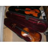 Two cased violins