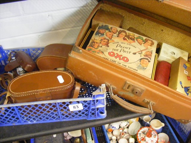 A carton of curios to include camera, binoculars,