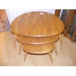 A nest of three Ercol pebble tables