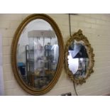 An oval gilt framed mirror together with an ornate oval mirror