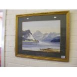 A framed watercolour depicting a mountain lake scene signed Grieg Hall