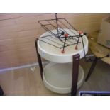 A retro trolley on castors together with a magazine rack and a retro coat rack