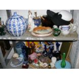 A quantity of mixed collectables to include Chinese pot, hats on two shelves etc.