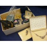 A small carton containing costume jewellery to include necklaces, marcasite necklace, brooches,