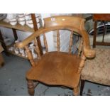 A light wood captain's chair