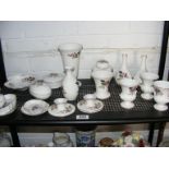 A quantity of Wedgwood Hathaway Rose ceramics to include vases, candlesticks, trinket pots etc.