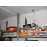 Two shelves containing a quantity of games to include Mouse Trap, Operation, Tank battle,