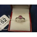 A 9ct white gold pink sapphire and diamond cluster ring