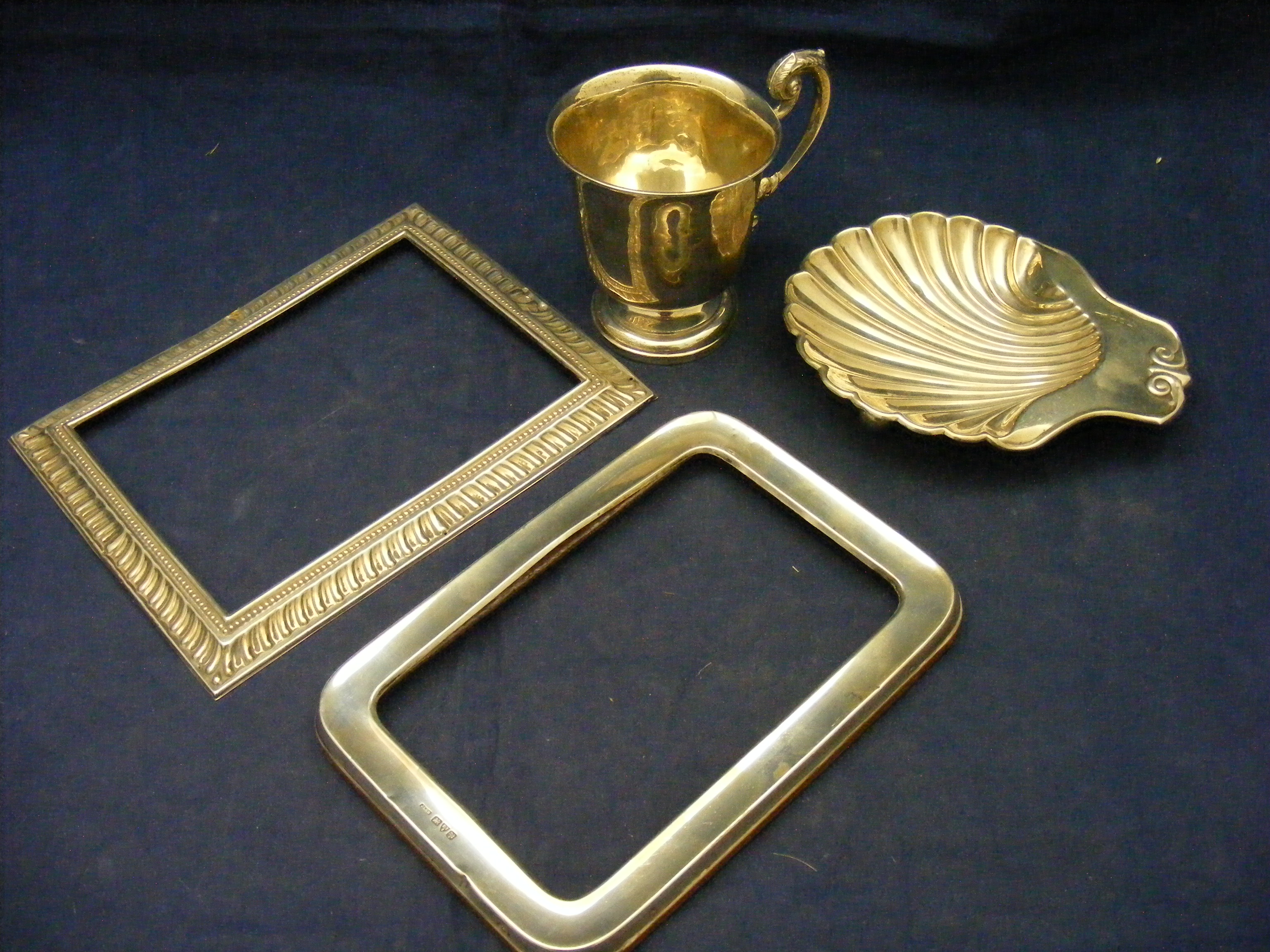 Two silver photo frames (a/f) together with a silver cup and a silver bon bon dish