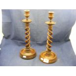 A pair of Mahogany barley twist candlesticks (one a/f)