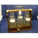 A tantalus complete with three decanters