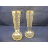 A pair of cut glass vases with silver rims