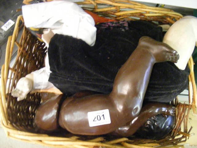 A basket containing a quantity of dolls