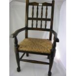 A childs chair with wicker seat