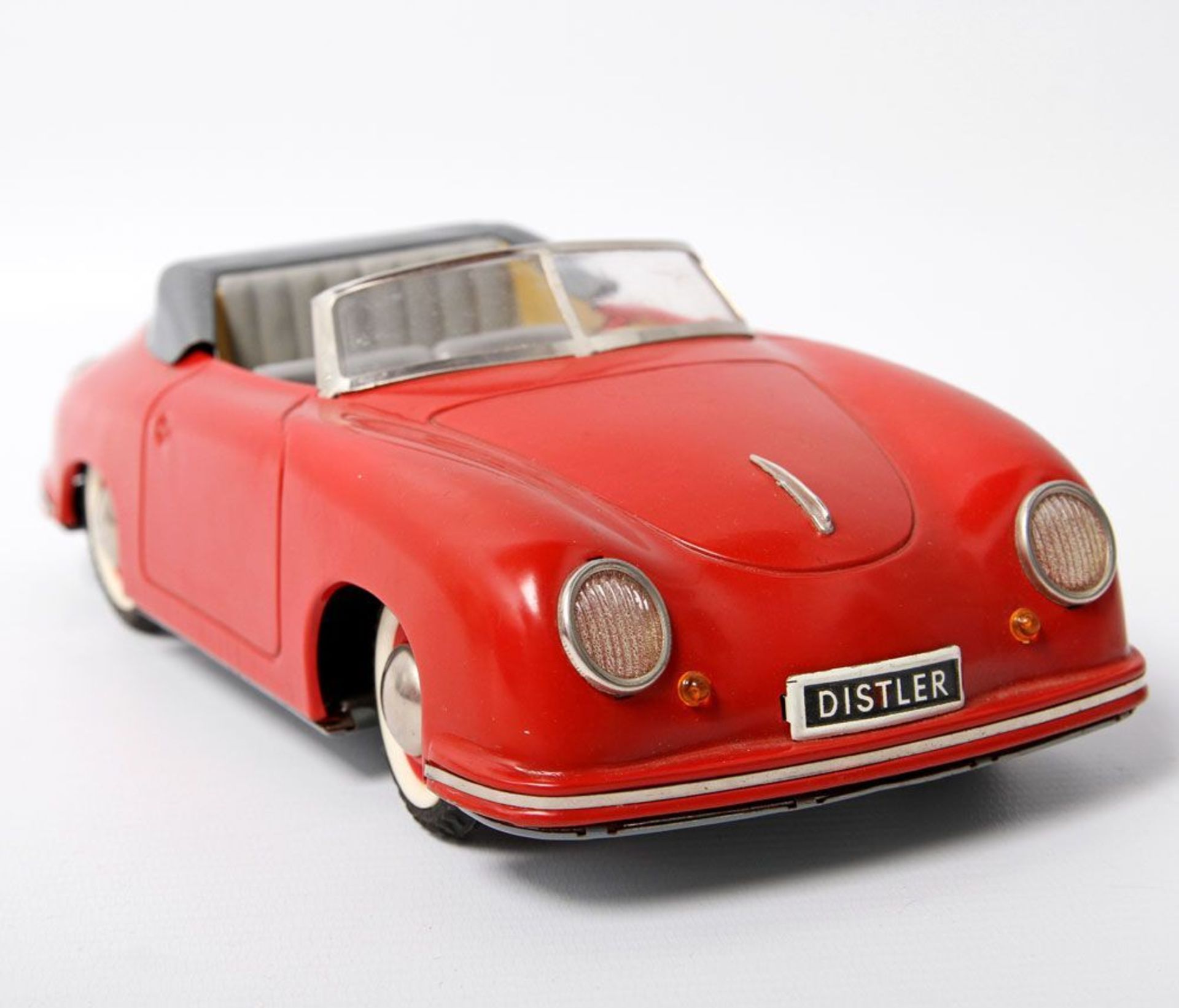 Opening: 120 EUR        DISTLER ELECTRO MATIC Porsche 7500, Mitte 20.Jh., Blech, rot und grau.