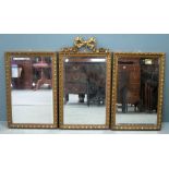 Set of three gilt framed mirrors, the central mirror with ribbon surmount