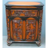 Oriental hardwood cabinet with hinged top above hinged drop flap over two cupboard doors