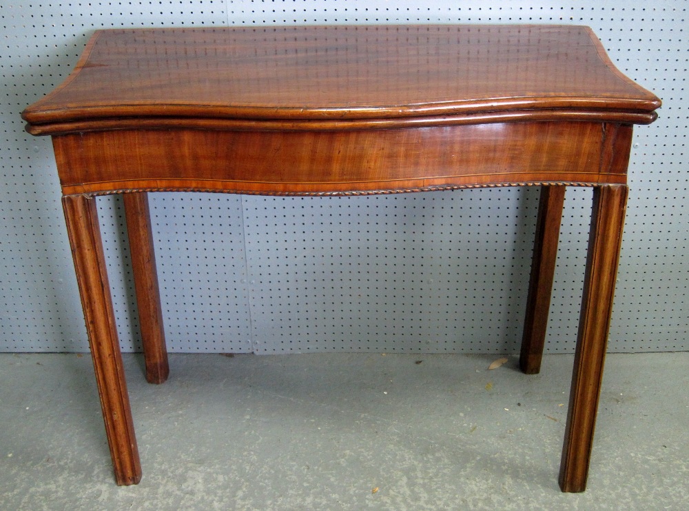 Mahogany and satinwood crossbanded serpentine card table on four sqaure legs