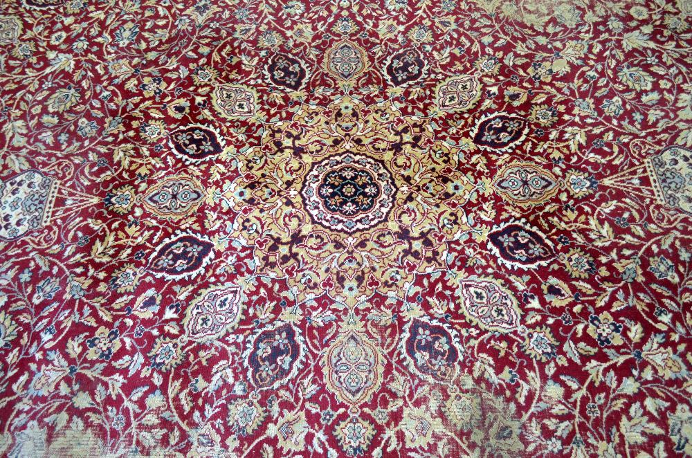 Large Persian red ground carpet with central shaped medallion and floral motifs, with multiple - Image 2 of 9