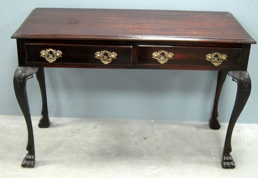 Early 20th century mahogany side table of two drawers, stamped M.Butler of Dublin, on carved