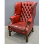 Red leather button back wing armchair In good order, minor wear to leather most notable to arms