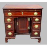 19th century mahogany and crossbanded kneehole desk, brushing slide above seven drawer and