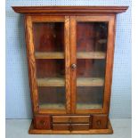 Oak bookcase with two glazed doors above drawers