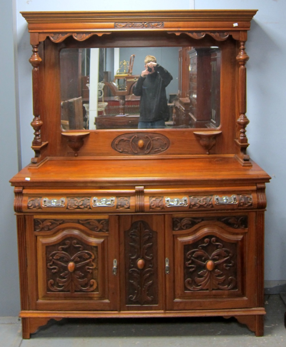 Walnut mirror backed sideboard with two drawers over two cupboard doors