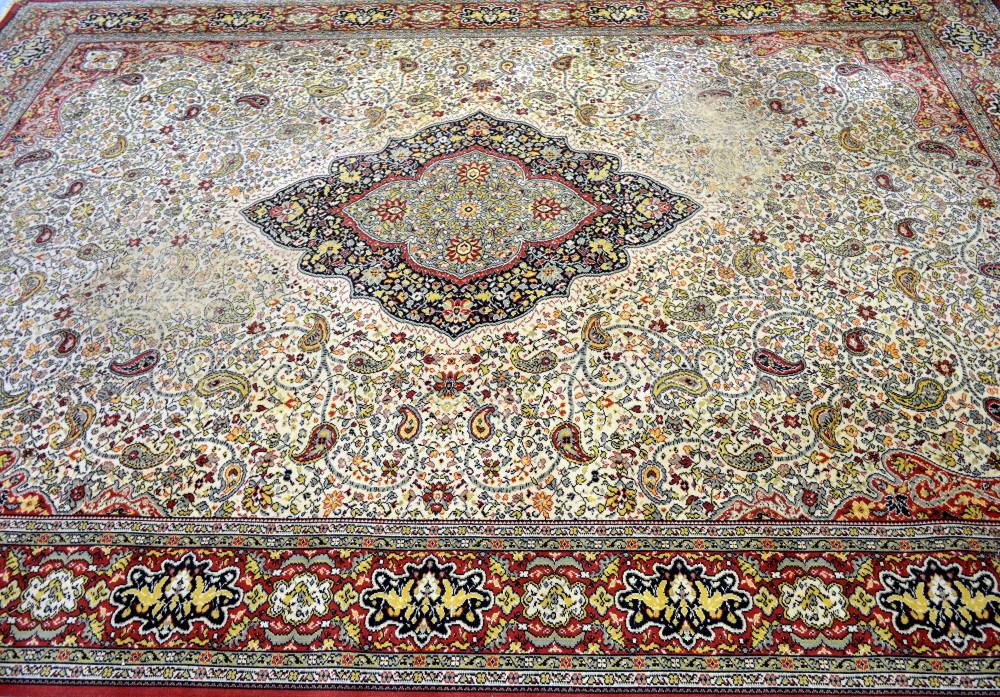 Large Persian cream ground carpet with central shaped medallion and floral motifs, multiple borders,