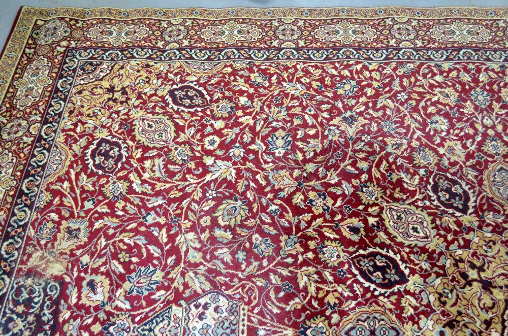 Large Persian red ground carpet with central shaped medallion and floral motifs, with multiple - Image 7 of 9