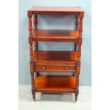 19th century mahogany four tier what not, with a single drawer on turned supports to castors,