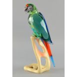 Swarovski Paradise birds Macaw chrome green, No. 685824,  sits on a wooden base, designed by
