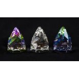 Three Swarovski faceted cone shaped paperweights, one in clear crystal, one in shades of pinks and
