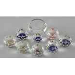 Ten Swarovski crystal round faceted paperweights of various sizes with commemorative and souvenir