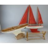 Two early 20th century painted wooden pond yachts, each 46cm long,