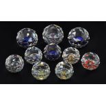 Eight Swarovski crystal round faceted paperweights of various sizes with commemorative and